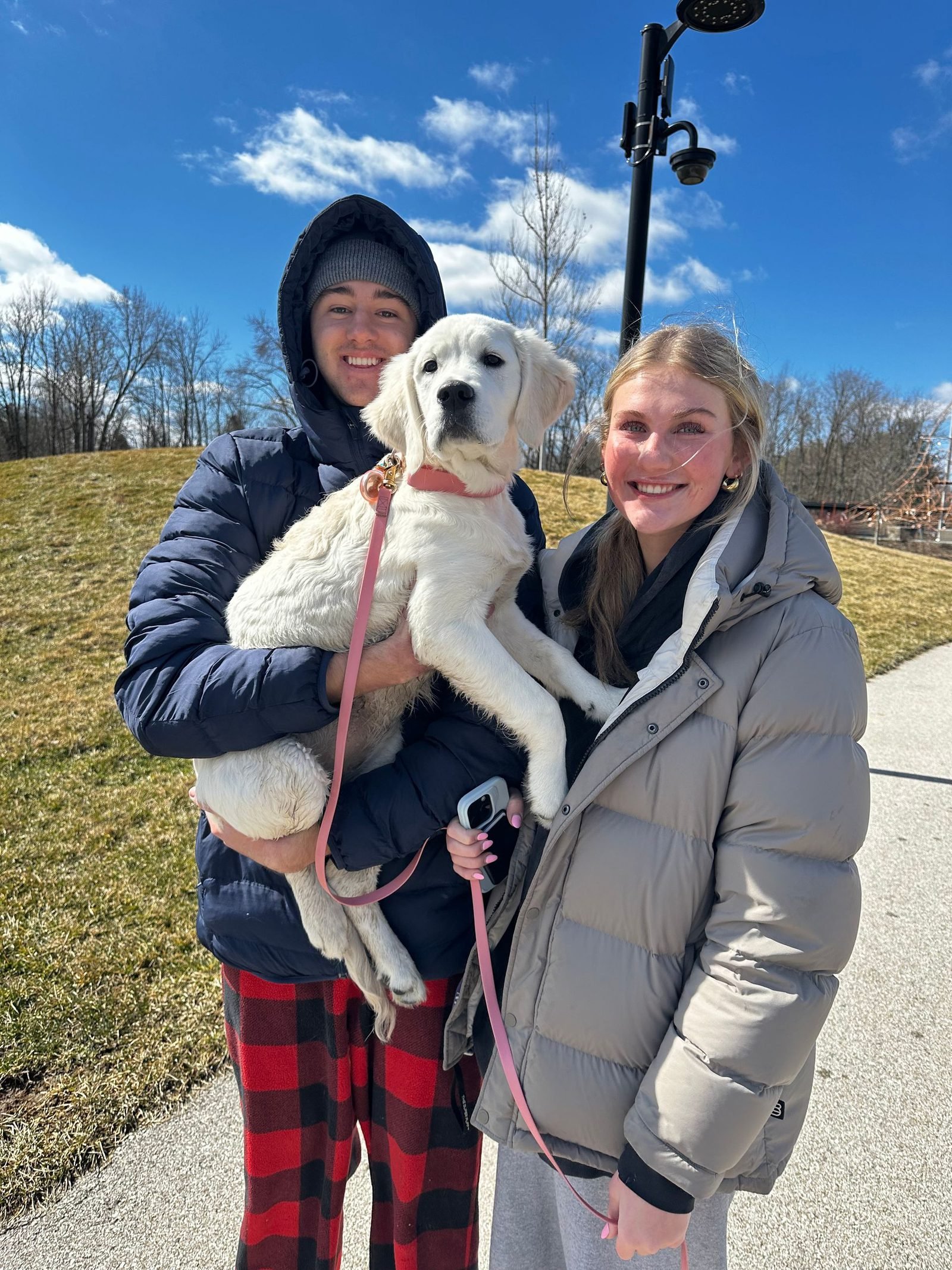 Family holding their new puppy after training