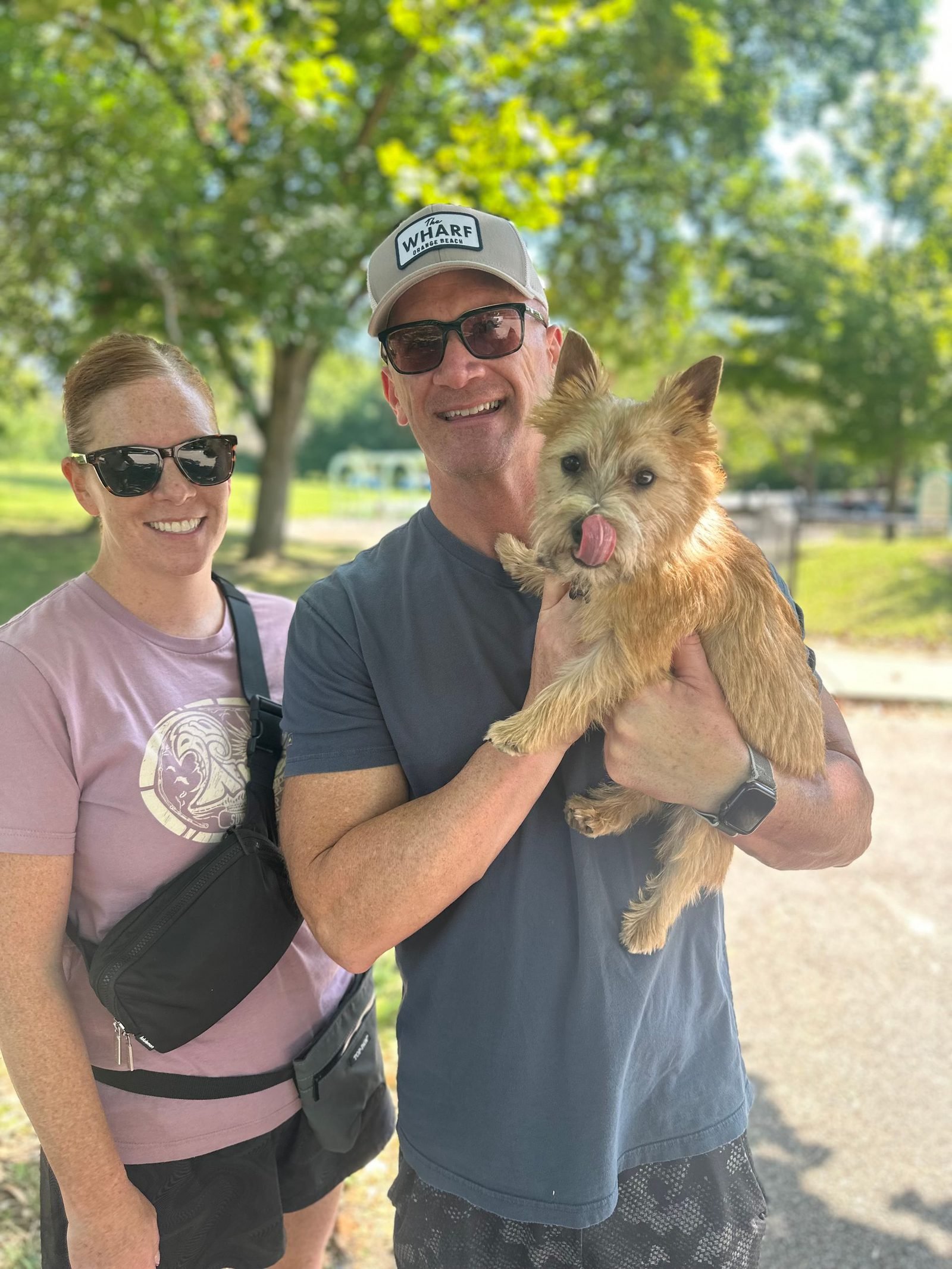 Happy clients with their small dog after training